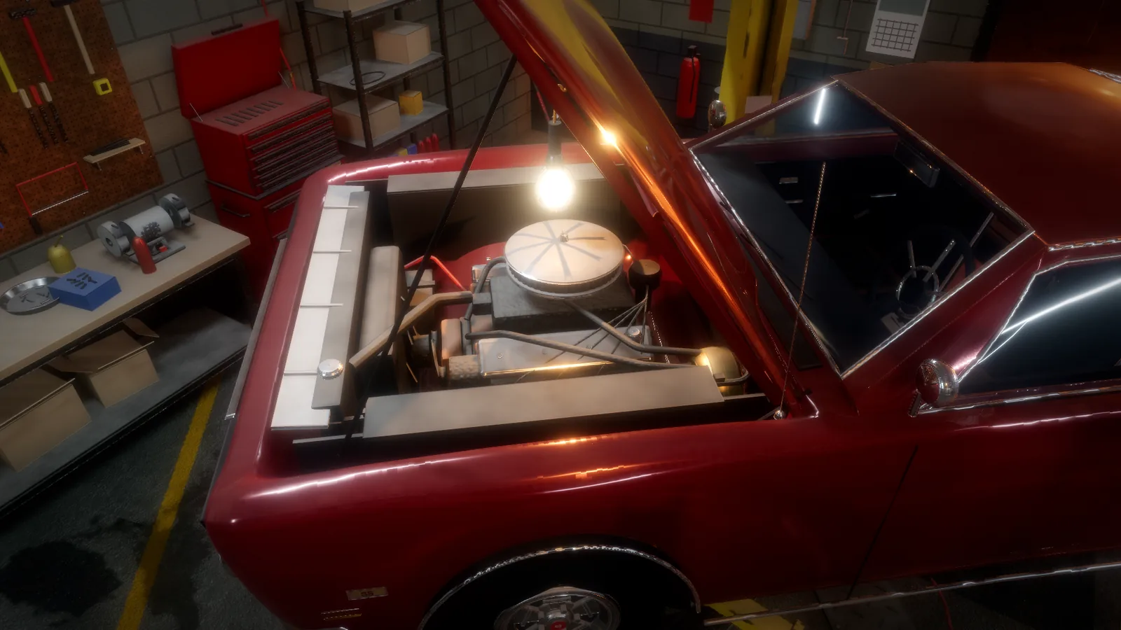 A work lamp in a red muscle car's open engine bay